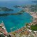 A city built along a coast with a marina and a cluster of islands